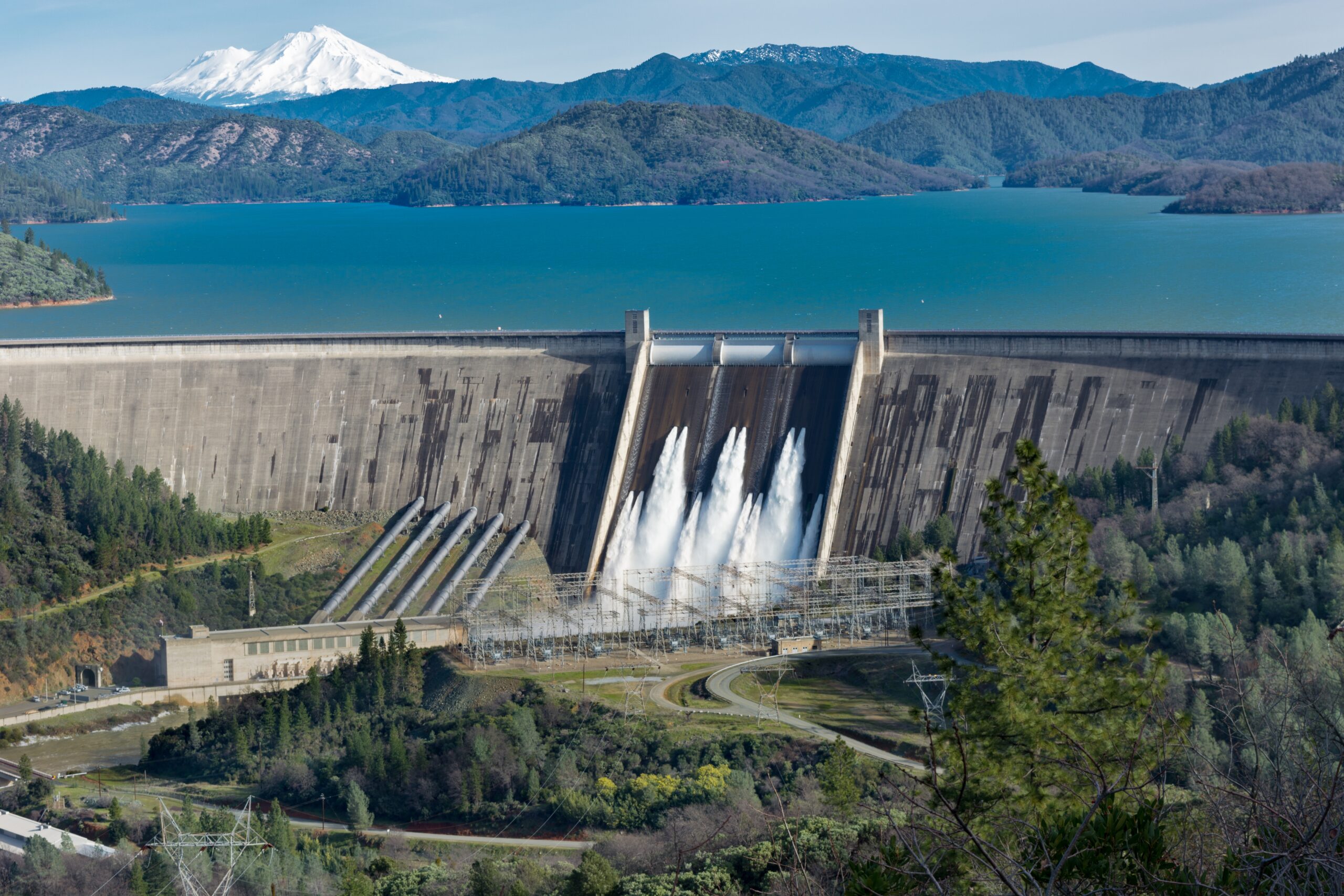 picture-shasta-dam-surrounded-by-roads-trees-with-lake-mountains-scaled.jpg